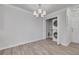 Dining area featuring modern chandelier, wood flooring, and a convenient laundry closet at 5041 Royal Palms Way # 203, New Port Richey, FL 34652