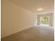 Spacious unfinished bonus room ready for customization with AC unit and back door at 5041 Royal Palms Way # 203, New Port Richey, FL 34652