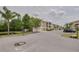 Street view showcasing well-maintained condo building exteriors and landscaped grounds at 5041 Royal Palms Way # 203, New Port Richey, FL 34652