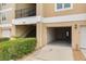 View of a residential condo featuring an open garage and staircase at 5041 Royal Palms Way # 203, New Port Richey, FL 34652