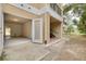 Exterior view of an attached garage and stairwell for building access at 5041 Royal Palms Way # 203, New Port Richey, FL 34652