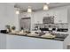 Kitchen features a breakfast bar with modern white cabinets, stainless steel appliances, and decorative backsplash at 5041 Royal Palms Way # 203, New Port Richey, FL 34652