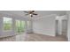 Bright living room featuring wood floors, a ceiling fan, and sliding glass doors to the balcony at 5041 Royal Palms Way # 203, New Port Richey, FL 34652