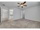 Comfortable main bedroom featuring neutral carpet and ensuite bath and closet at 5041 Royal Palms Way # 203, New Port Richey, FL 34652