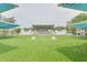 A spacious outdoor stage area with a green lawn, perfect for community events and performances at 5041 Royal Palms Way # 203, New Port Richey, FL 34652