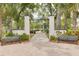 Inviting entrance to Sims Park, featuring a manicured walkway, beautiful landscaping, and benches for relaxation at 5041 Royal Palms Way # 203, New Port Richey, FL 34652