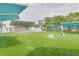 Lush green park with an outdoor stage, picnic shelters, and playground, creating an ideal recreational space at 5041 Royal Palms Way # 203, New Port Richey, FL 34652