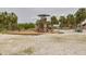 Community playground featuring a jungle gym, swing set, and surrounding palm trees for a Gathering-friendly atmosphere at 5041 Royal Palms Way # 203, New Port Richey, FL 34652