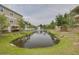Scenic view of a pond with fountain surrounded by lush landscaping in a well-maintained community at 5041 Royal Palms Way # 203, New Port Richey, FL 34652