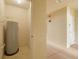 Utility room featuring water heater and access to the hallway at 5041 Royal Palms Way # 203, New Port Richey, FL 34652