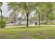 Picturesque waterfront view in a well-kept park, featuring a serene waterway, walking paths, and lush greenery at 5041 Royal Palms Way # 203, New Port Richey, FL 34652