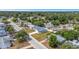 Charming single Gathering home featuring a newly installed grey roof with manicured lawn and mature trees in residential neighborhood at 5214 Idlewild St, New Port Richey, FL 34653