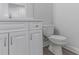 Updated half bathroom features a white vanity with quartz countertop and sleek fixtures at 5214 Idlewild St, New Port Richey, FL 34653
