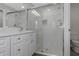 Bright bathroom features double vanity and a modern glass-enclosed shower with marble tiling at 5214 Idlewild St, New Port Richey, FL 34653