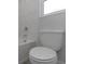 A bright bathroom with a toilet and a window with natural light at 5214 Idlewild St, New Port Richey, FL 34653