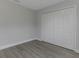 A clean bedroom features grey vinyl floors and a closet for ample storage at 5214 Idlewild St, New Port Richey, FL 34653