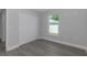 This bedroom features a closet, window with natural light, and luxury vinyl plank flooring at 5214 Idlewild St, New Port Richey, FL 34653