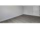 This bedroom features gray wood-look flooring and neutral paint colors at 5214 Idlewild St, New Port Richey, FL 34653
