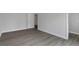 Bedroom features fresh paint, base molding, and vinyl wood flooring at 5214 Idlewild St, New Port Richey, FL 34653