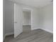 An airy bedroom featuring gray wood-look floors and an open doorway at 5214 Idlewild St, New Port Richey, FL 34653