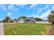 Charming single-story home featuring a two-car garage, covered front porch, and a large front yard at 5214 Idlewild St, New Port Richey, FL 34653