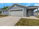 Picture of a single-story home with garage, covered entryway and well manicured lawn at 5214 Idlewild St, New Port Richey, FL 34653