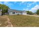 Picture of a single-story home with green lawn, landscaped shrubs and two car garage at 5214 Idlewild St, New Port Richey, FL 34653