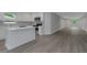 Bright kitchen featuring white cabinets, stainless steel appliances, and an island connecting to the living area at 5214 Idlewild St, New Port Richey, FL 34653