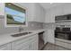 Well-lit kitchen showcases stainless steel appliances and white cabinets with modern hardware at 5214 Idlewild St, New Port Richey, FL 34653
