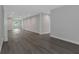 Spacious living room with gray wood floors and new paint throughout at 5214 Idlewild St, New Port Richey, FL 34653