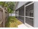 View of a home's screened in patio with a view of the backyard at 5214 Idlewild St, New Port Richey, FL 34653