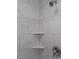 The shower features a corner shelf and white faux marble tile at 5214 Idlewild St, New Port Richey, FL 34653