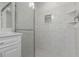 The shower has white subway tile, glass doors, and a recessed shelf at 5214 Idlewild St, New Port Richey, FL 34653