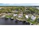 Aerial view of waterfront homes with docks, set against a lush green landscape and open sky at 5422 Foley Sq, New Port Richey, FL 34652