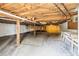 Unfinished basement with exposed ceiling, beams, and concrete floor, offering potential for customization at 5422 Foley Sq, New Port Richey, FL 34652