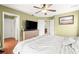 Spacious bedroom featuring a ceiling fan, a TV on a dresser, and an open door to the hallway at 5422 Foley Sq, New Port Richey, FL 34652