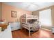 Bedroom featuring bunk beds, wood floors, and bright, natural light at 5422 Foley Sq, New Port Richey, FL 34652