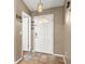 Bright entryway featuring decorative tile flooring, a stylish light fixture, and a welcoming white door at 5422 Foley Sq, New Port Richey, FL 34652