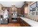 Modern kitchen with stainless steel double oven, wood cabinets, and window view at 5422 Foley Sq, New Port Richey, FL 34652