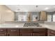 Granite countertop with cooktop in an open, updated, modern kitchen with wood floors at 5422 Foley Sq, New Port Richey, FL 34652