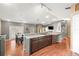 Bright kitchen with gray walls, wood floors, island cooktop, and breakfast table at 5422 Foley Sq, New Port Richey, FL 34652