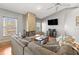 Cozy living room showcasing a large fireplace, a comfortable sectional sofa, and abundant natural light at 5422 Foley Sq, New Port Richey, FL 34652