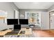 Office with two monitors, a window view, and dark wood floors at 5422 Foley Sq, New Port Richey, FL 34652