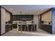 Modern kitchen with custom cabinets, stone countertops, an island with seating, and stainless steel appliances at 5457 Creek Ridge Rd, Brooksville, FL 34601