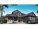 Two-story home featuring a covered porch, attached garage, complementary landscaping, and architectural design at 5477 Creek Ridge Rd, Brooksville, FL 34601
