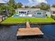 Aerial view of a waterfront property featuring a pool, backyard, and private dock at 5512 Tropic Dr, New Port Richey, FL 34653
