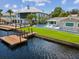 An aerial shot of the property highlighting its waterfront location, private dock, and backyard pool at 5512 Tropic Dr, New Port Richey, FL 34653