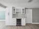 Kitchen area with built-in wine fridge and custom cabinetry at 5512 Tropic Dr, New Port Richey, FL 34653
