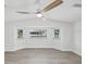 Bright, airy bedroom featuring a modern ceiling fan and a scenic bay window at 5512 Tropic Dr, New Port Richey, FL 34653