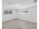 Bright bedroom featuring wood-look flooring and lots of natural light at 5512 Tropic Dr, New Port Richey, FL 34653